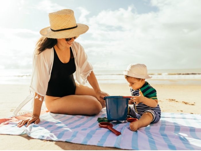 A person and baby on a beach